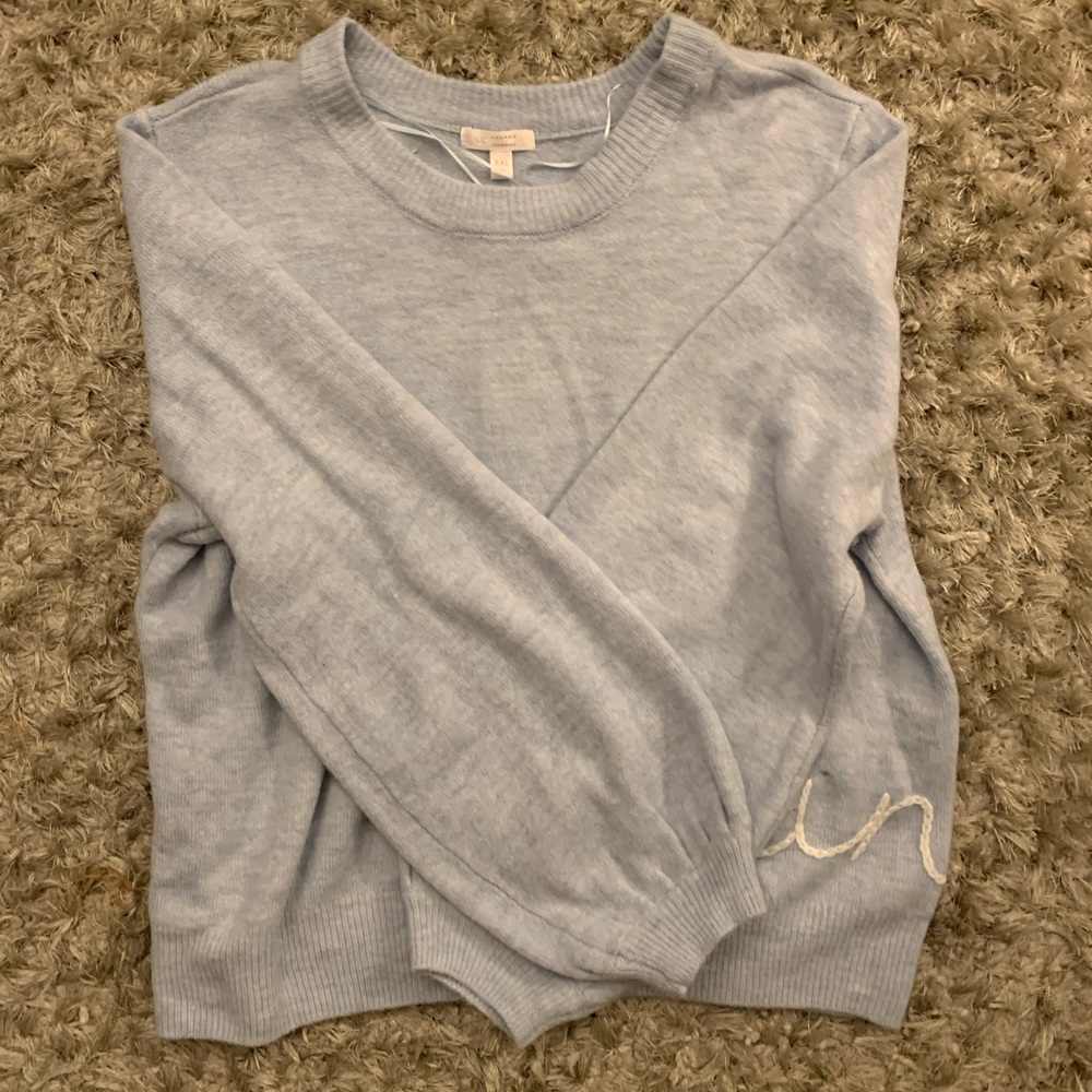 Blue sweater (says Sunday on it)